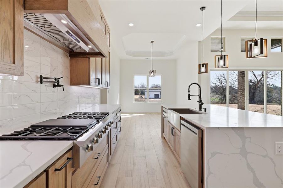 Gas range with pot filler. Look at that waterfall island! Gas range with pot filler. Look at that waterfall island!