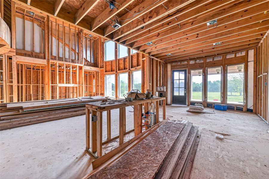 Open unfinished space showcasing framing and build progress.