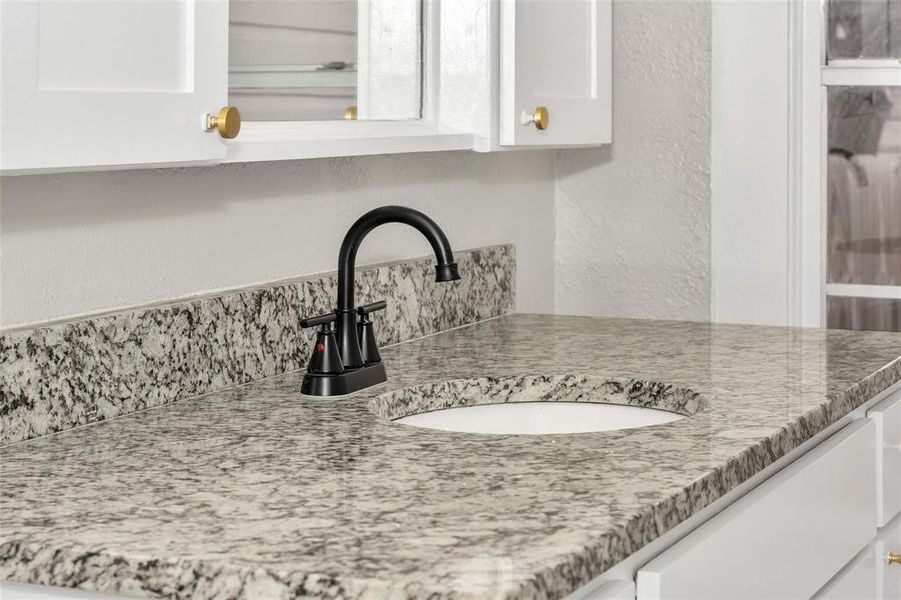 Detailed view of a sink and a textured wall Detailed view of a sink and a textured wall