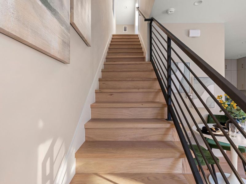 Stairs featuring wood finished floors and recessed lighting Stairs featuring wood finished floors and recessed lighting