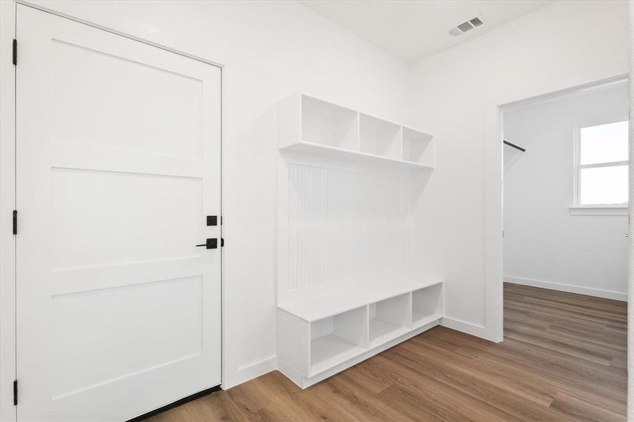 Mudroom with light hardwood / wood-style floors