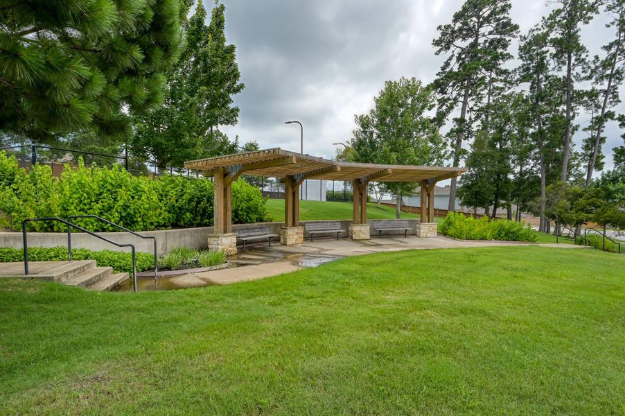 Enjoy beautifully maintained community green space featuring shaded seating areas. Enjoy beautifully maintained community green space featuring shaded seating areas.