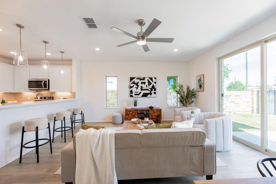 Living area featuring ceiling fan, recessed lighting, and light wood-type flooring