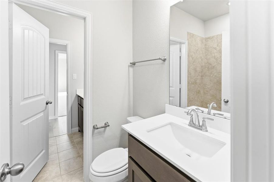 Bathroom with vanity and light tile patterned flooring