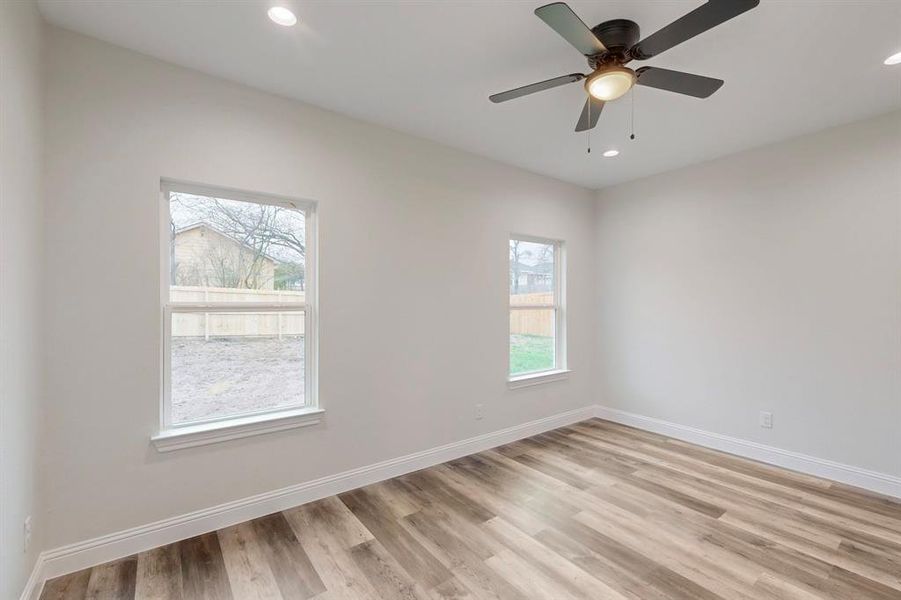 Unfurnished room featuring ceiling fan and light wood-type flooring