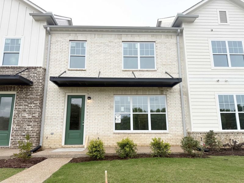 View of front facade featuring a front lawn and brick siding View of front facade featuring a front lawn and brick siding