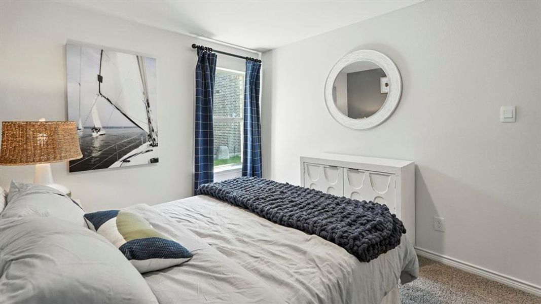 Carpeted bedroom with baseboards