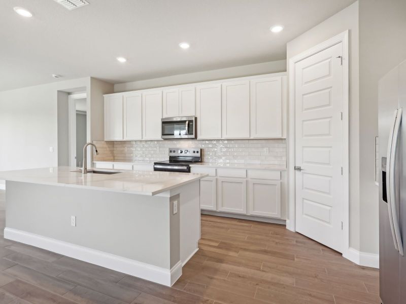 Kitchen in the Emilia floorplan at 8993 Dahlia Circle