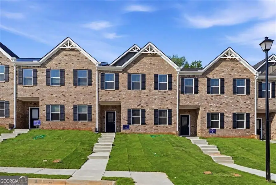 Front exterior of a new home in Parkway James, Snellville, GA, highlighting curb appeal (Image 18). Front exterior of a new home in Parkway James, Snellville, GA, highlighting curb appeal (Image 18).