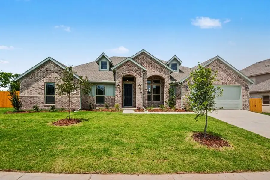 Front exterior of a new home in Cole Crossing Estates, DeSoto, TX, highlighting curb appeal (Image 2). Front exterior of a new home in Cole Crossing Estates, DeSoto, TX, highlighting curb appeal (Image 2).