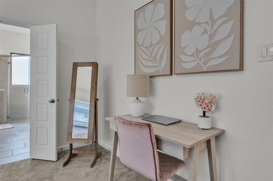 Carpeted room featuring a neutral wall color, a white paneled door, and visible light switches Carpeted room featuring a neutral wall color, a white paneled door, and visible light switches