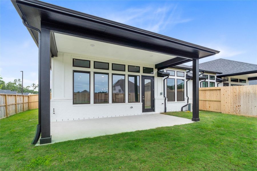 The covered patio offers a functional extension of your indoor living space, providing shade from the sun and shelter from the elements for comfortable outdoor dining or relaxation.