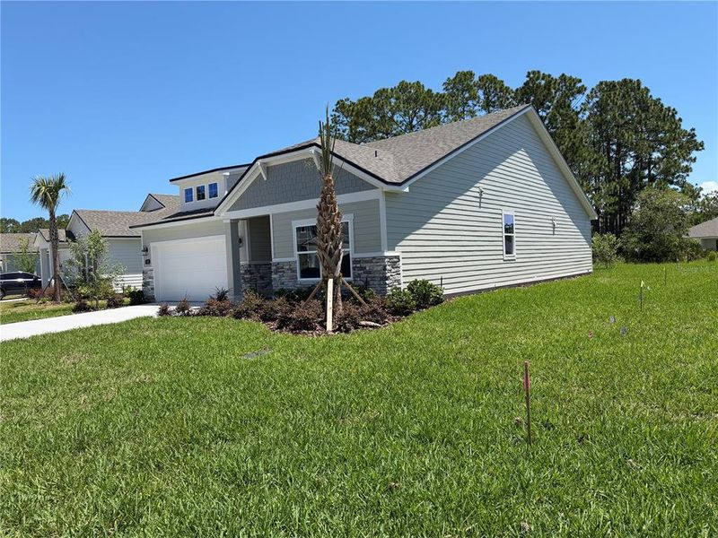 Front exterior of a new home in Reserve East, Flagler Beach, FL, highlighting curb appeal (Image 24).