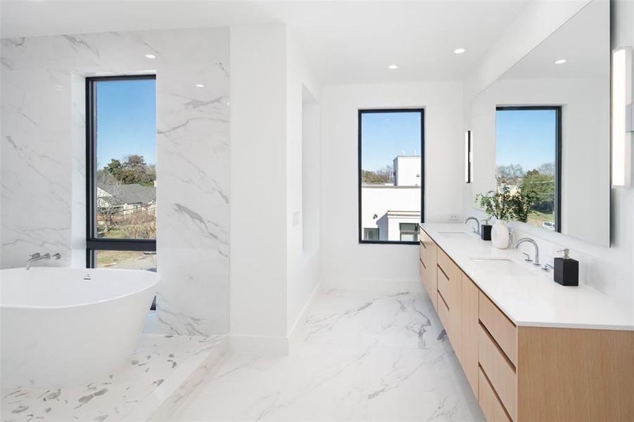 Bathroom with vanity and a tub