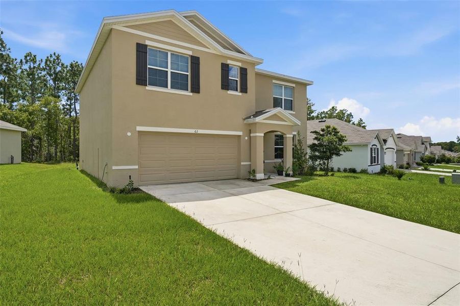 Front exterior of a new home in Lake Diamond, Ocala, FL, highlighting curb appeal (Image 27).