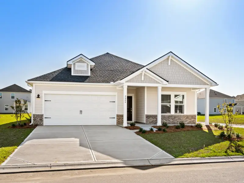 Front exterior of a new home in Waterside - Coastline Series, Longs, SC, highlighting curb appeal (Image 1). Front exterior of a new home in Waterside - Coastline Series, Longs, SC, highlighting curb appeal (Image 1).