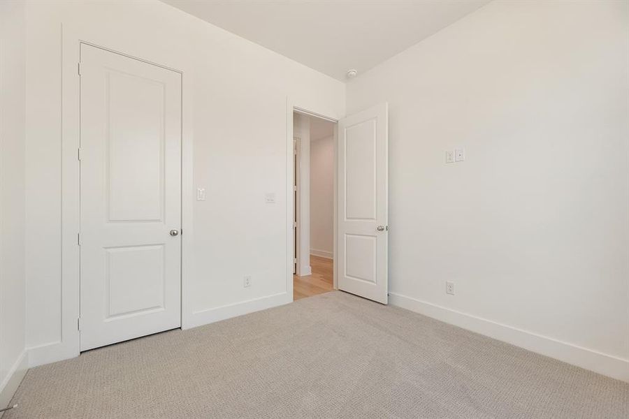 Unfurnished bedroom with baseboards and carpet Unfurnished bedroom with baseboards and carpet