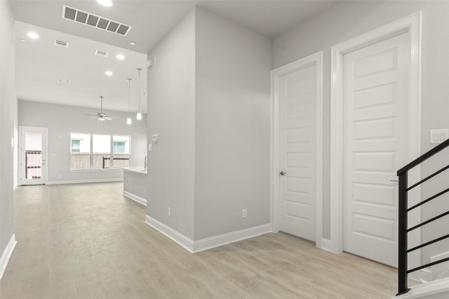 Hall with light wood-style floors and recessed lighting Hall with light wood-style floors and recessed lighting