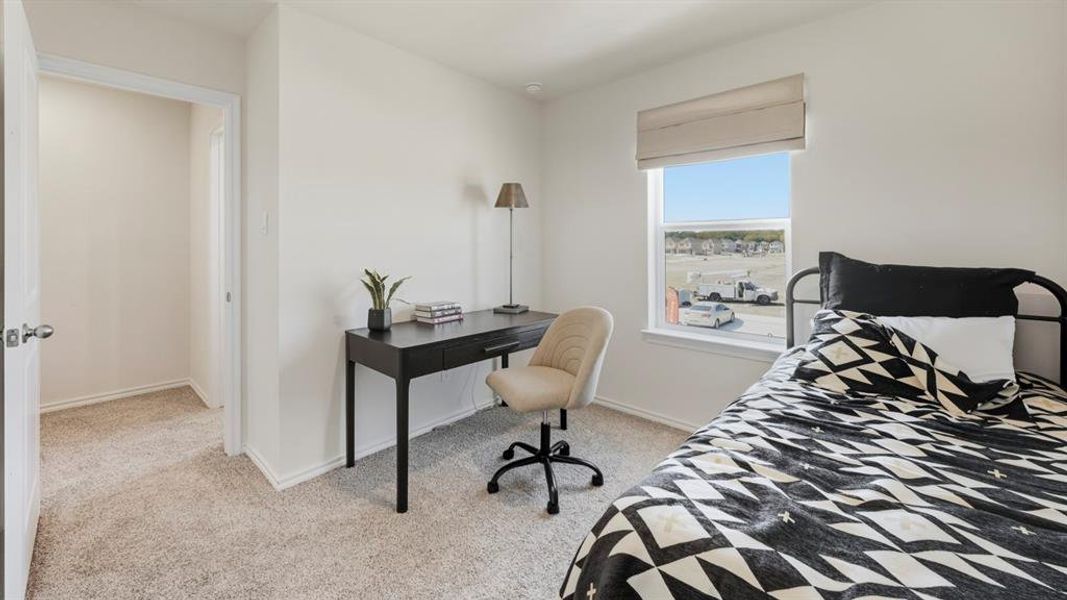 Bedroom featuring light colored carpet and baseboards