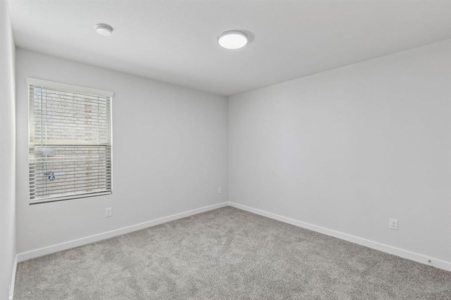 Bedroom in the Harrison home plan by Trophy Signature Homes – REPRESENTATIVE PHOTO