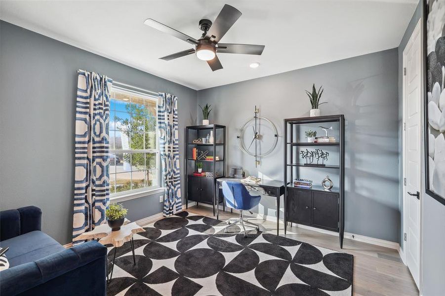 Home office with ceiling fan and light hardwood / wood-style floors