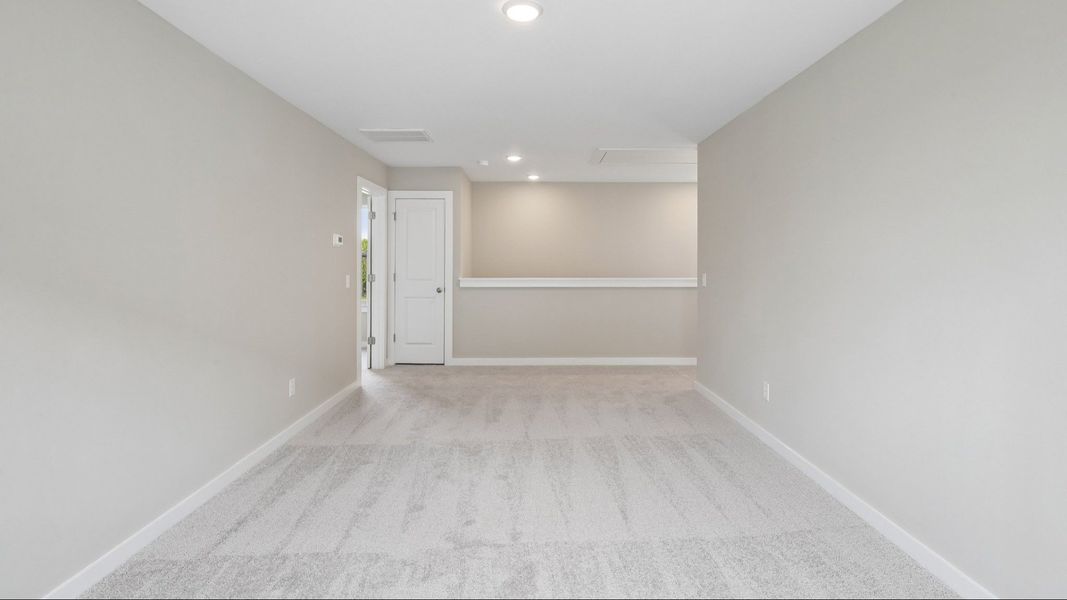 Second Floor Loft area with view of stairs and carpet