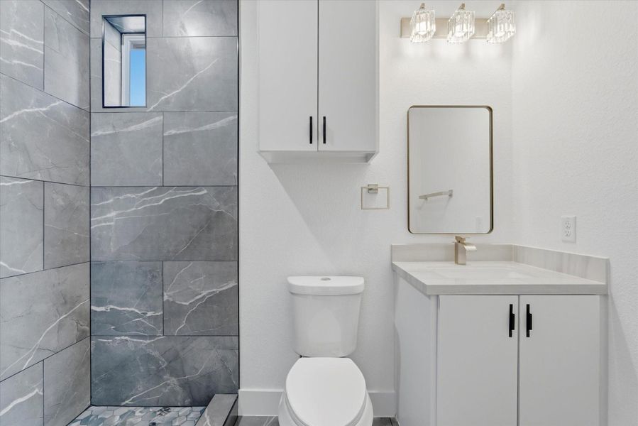 The primary bath offers plenty of storage, and a spacious stand up shower.