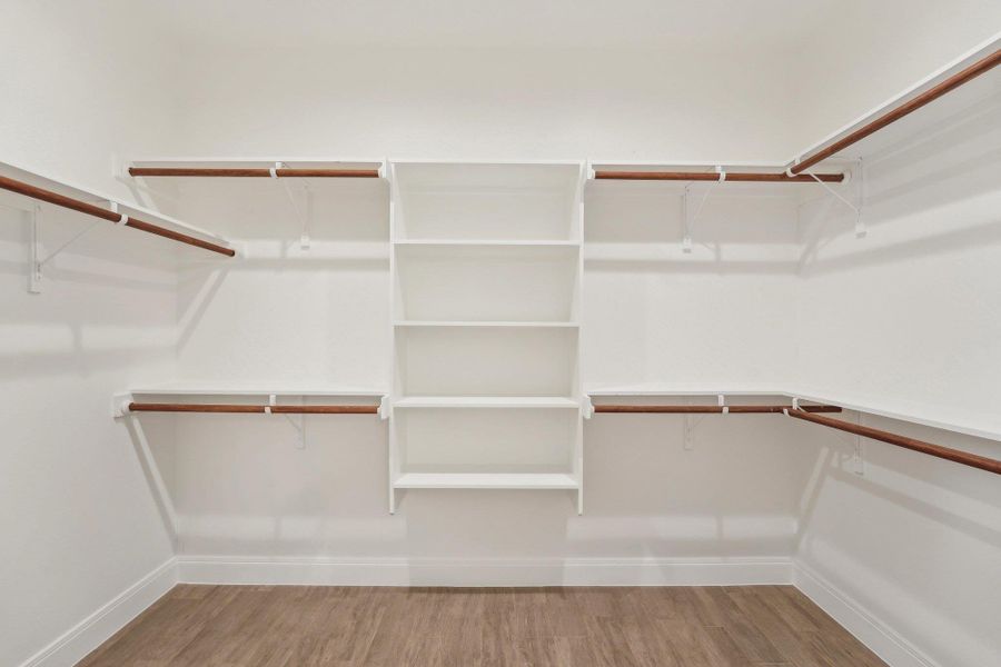 Spacious Primary closet featuring wood style floors Spacious Primary closet featuring wood style floors