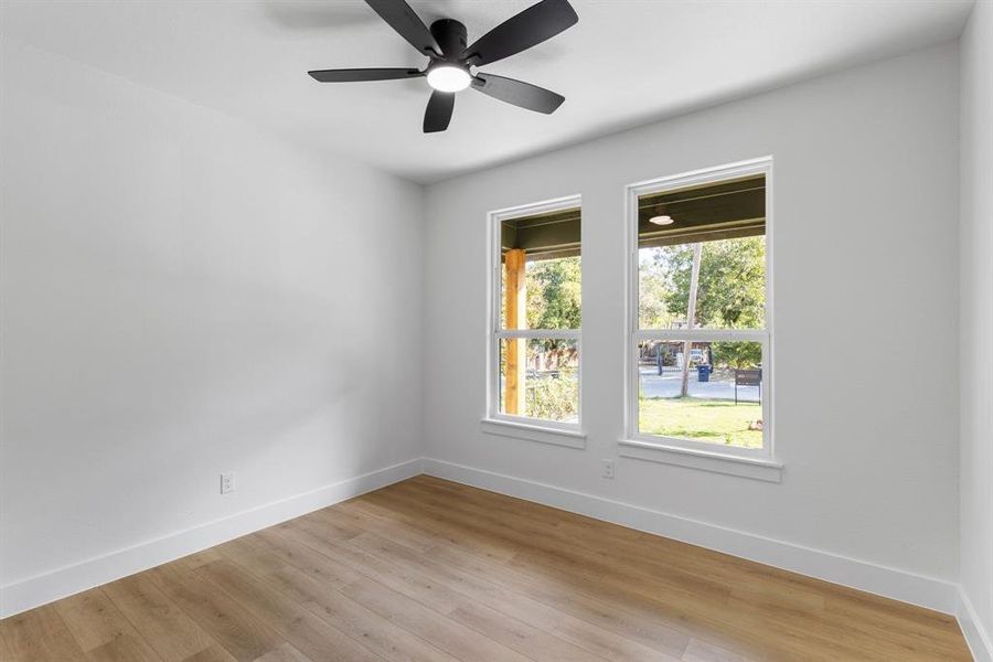 Spare room with light wood-type flooring and ceiling fan