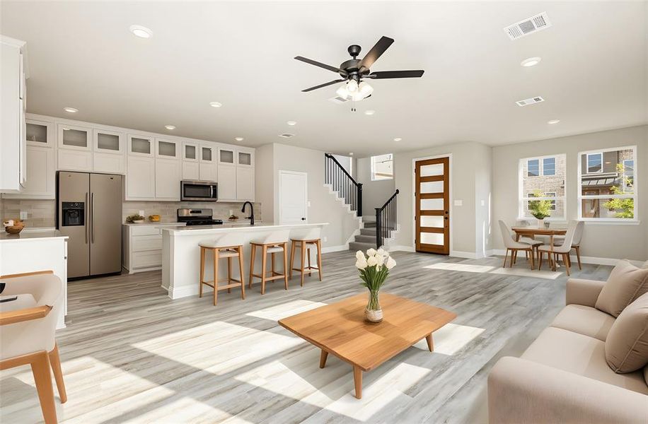 Living room featuring stairway, a ceiling fan, recessed lighting, and light wood finished floors