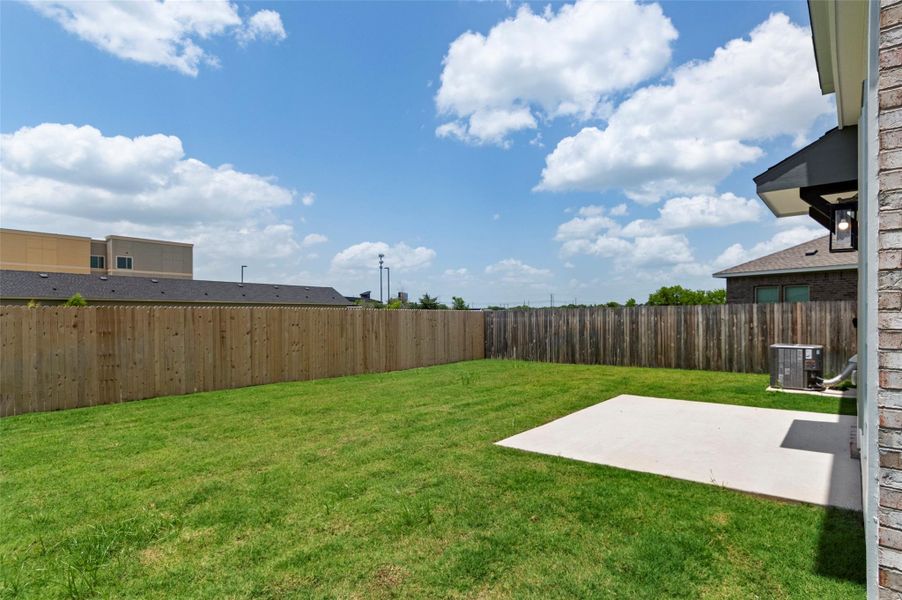Fenced backyard featuring a patio