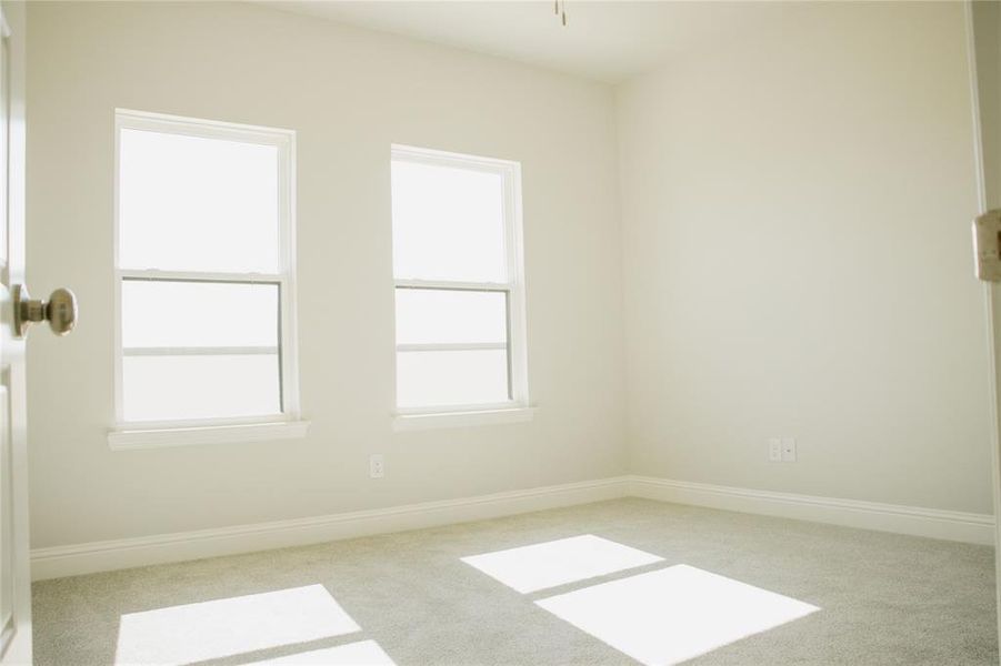 Empty room featuring light carpet