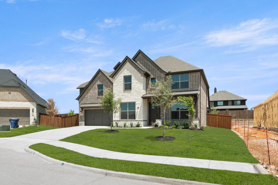 Front exterior of a new home in Redden Farms, Midlothian, TX, highlighting curb appeal (Image 2). Front exterior of a new home in Redden Farms, Midlothian, TX, highlighting curb appeal (Image 2).