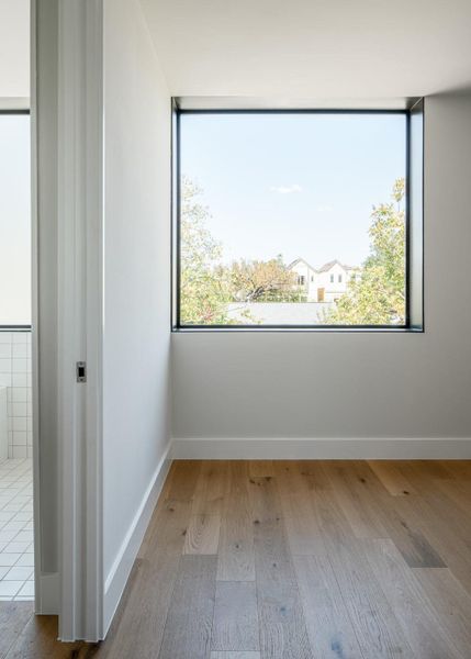 Unfurnished room featuring light wood finished floors and healthy amount of natural light