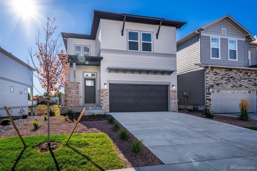 Front exterior of a new home in Trailside at Cottonwood Creek, Colorado Springs, CO, highlighting curb appeal (Image 2).