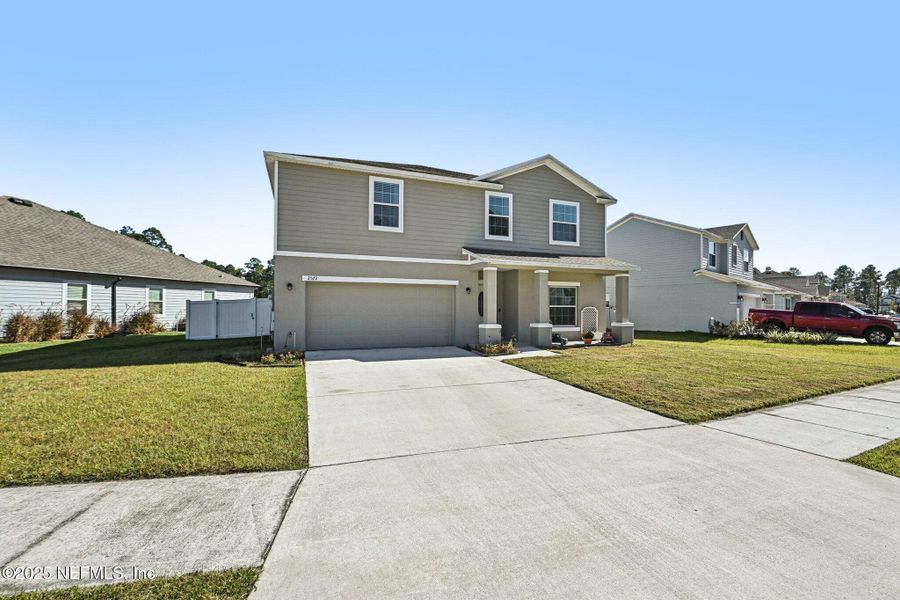 Front exterior of a new home in Village Park, Green Cove Springs, FL, highlighting curb appeal (Image 25).