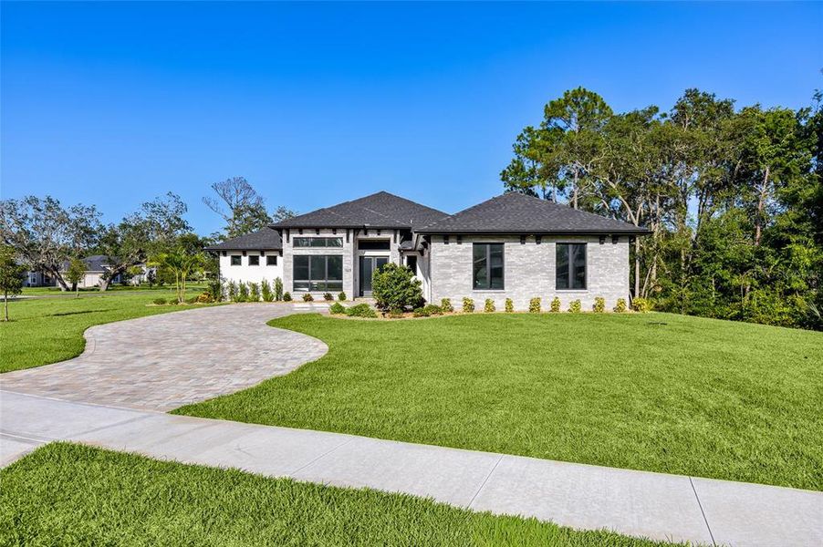 Front exterior of a new home in , New Smyrna Beach, FL, highlighting curb appeal (Image 26). Front exterior of a new home in , New Smyrna Beach, FL, highlighting curb appeal (Image 26).