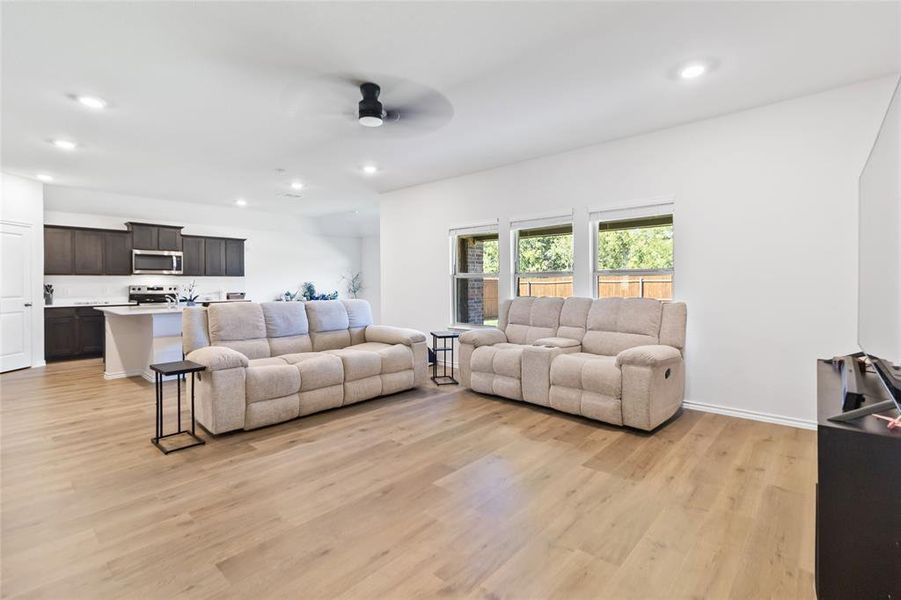 Living area with recessed lighting, light wood-type flooring, and ceiling fan