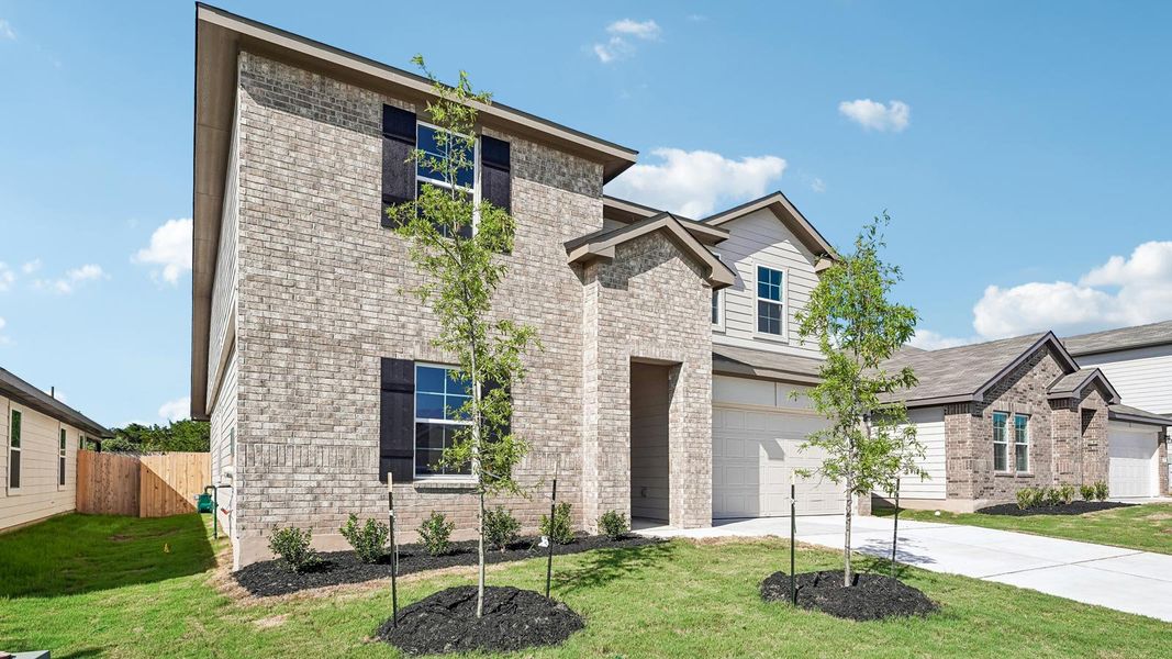 Front exterior of a new home in Carillon, Manor, TX, highlighting curb appeal (Image 2). Front exterior of a new home in Carillon, Manor, TX, highlighting curb appeal (Image 2).