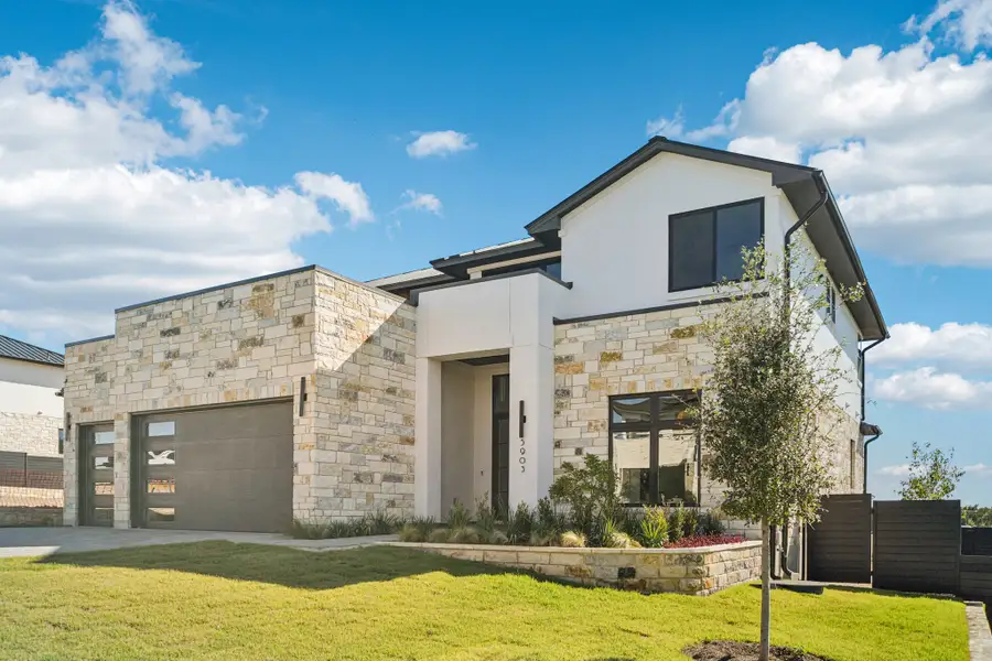 Front exterior of a new home in Milky Way at River Place, Austin, TX, highlighting curb appeal (Image 2).