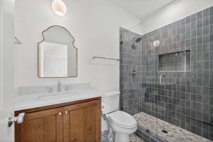 Full bathroom featuring a shower stall and vanity Full bathroom featuring a shower stall and vanity