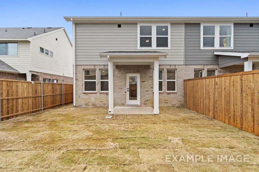 Rear view of property with a patio area and a yard