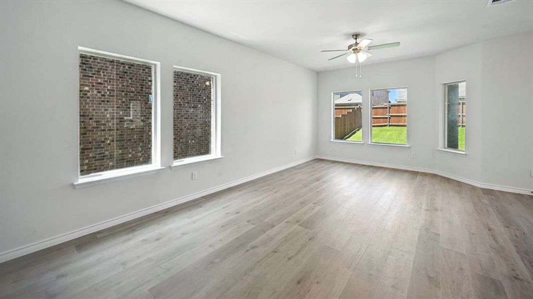 Empty room with light wood-type flooring and ceiling fan