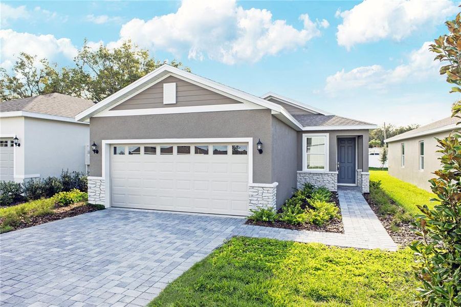 Front exterior of a new home in Highfield at Twisted Oaks, Wildwood, FL, highlighting curb appeal (Image 1). Front exterior of a new home in Highfield at Twisted Oaks, Wildwood, FL, highlighting curb appeal (Image 1).