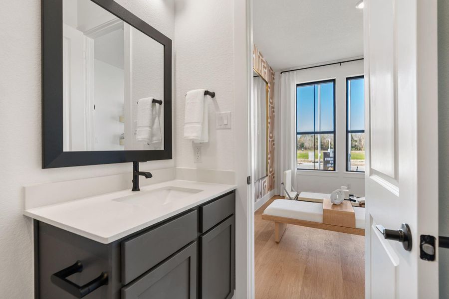 En-suite modern bathroom with a sleek vanity and quartz countertops.