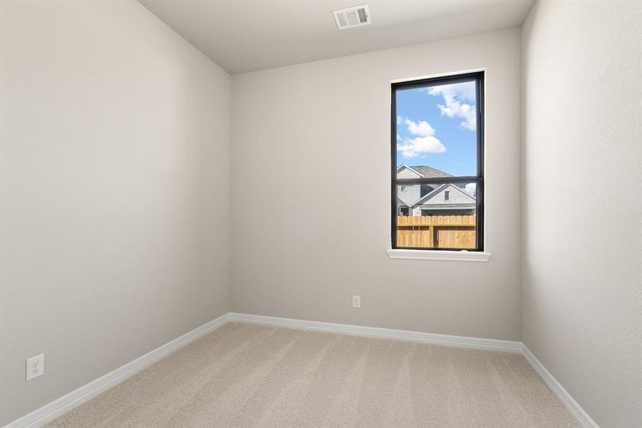 Your secondary bedroom features plush carpet, fresh paint, closet, and a large window that lets in plenty of natural lighting.