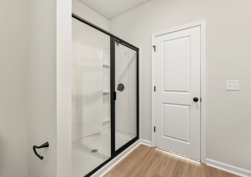 This bathroom has a glass-enclosed shower