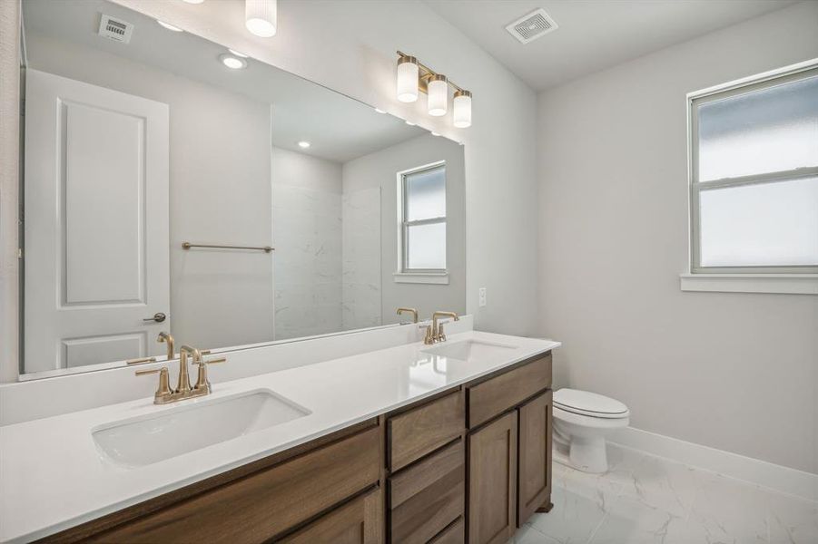 Bathroom featuring vanity and toilet