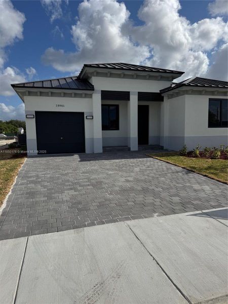 Front exterior of a new home in , Homestead, FL, highlighting curb appeal (Image 8). Front exterior of a new home in , Homestead, FL, highlighting curb appeal (Image 8).