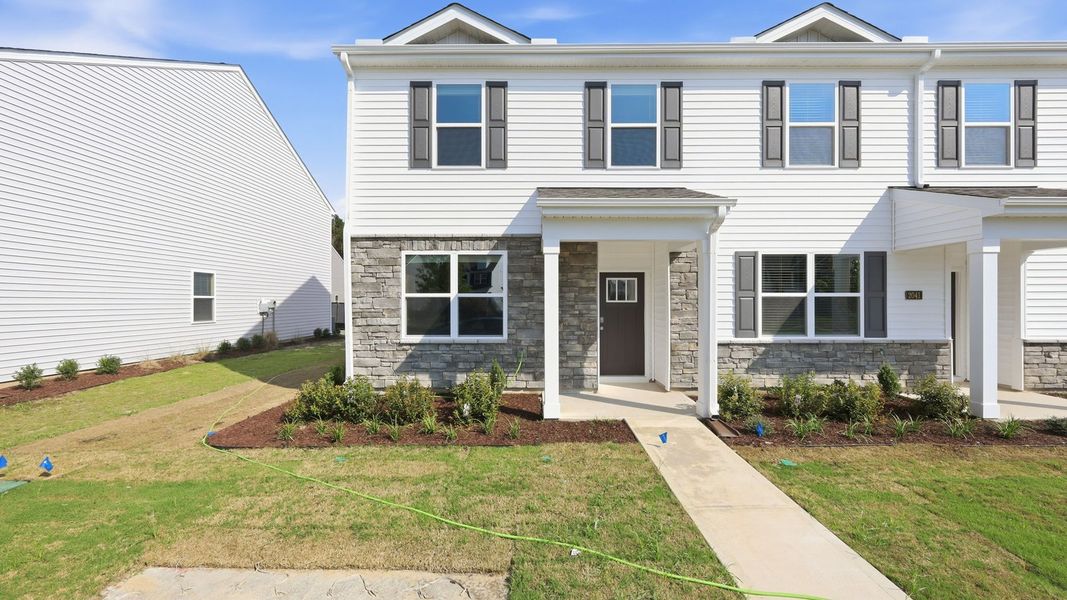 Front exterior of a new home in Clock Road Townhomes, New Bern, NC, highlighting curb appeal (Image 2). Front exterior of a new home in Clock Road Townhomes, New Bern, NC, highlighting curb appeal (Image 2).